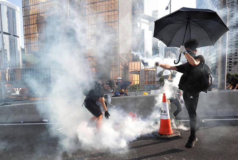 Protesters react after tear gas was fired by the police during a demonstration in support of the city-wide strike and to call for democratic reforms outside Central Government Complex in Hong Kong, China, August 5, 2019. REUTERS/Kim Kyung-Hoon