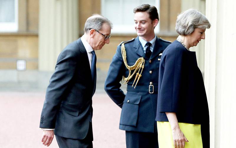 Theresa May arrives with her husband Philip May, left, at Buckingham Palace, London, Wednesday, July 13, 2016, where she will have an audience with Queen Elizabeth II to formally accept the position of Britain's Prime Minister. Earlier David Cameron resigned from the post during his meeting with the queen. (Steve Parsons/Pool Photo via AP) 