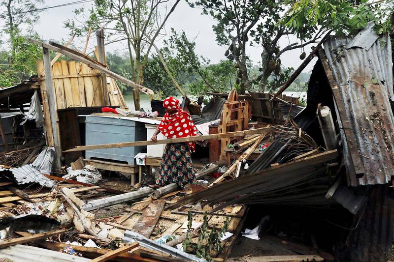 A woman clears her house that was demolished by the cyclone Amphan in Satkhira, Bangladesh May 21, 2020. REUTERS/Km Asad  NO RESALES. NO ARCHIVES