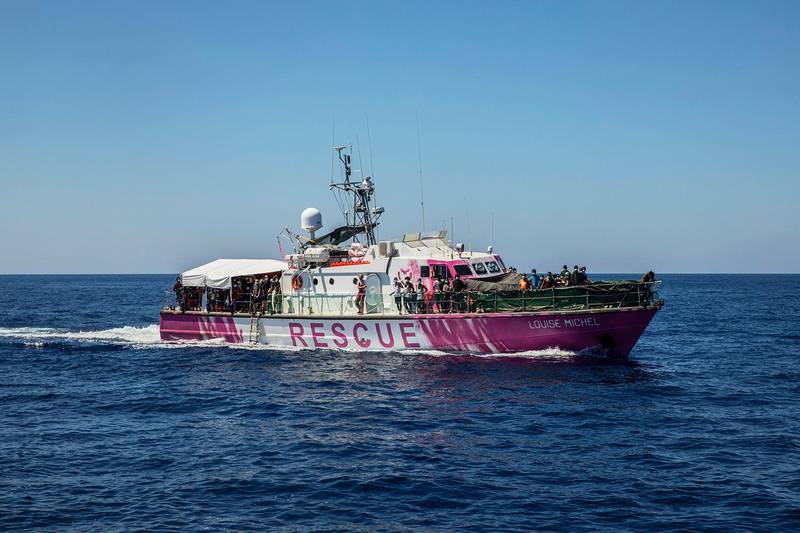 Louise Michel rescue vessel, a former French patrol boat currently manned by activists and funded by the renowned artist Banksy, is seen in the Central Mediterranean sea, at 50 miles south from Lampedusa, Friday, Aug. 28, 2020. A Berlin-based group says it has begun migrant rescue operations in the Mediterranean Sea with a bright pink former navy vessel sponsored by British artist Banksy. The group operating the MV Louise Michel, a sleek 30-meter (98-foot) ship named after a 19th century French feminist and anarchist, said late Thursday that it rescued 89 from an inflatable boat in distress.  (AP Photo/Santi Palacios)