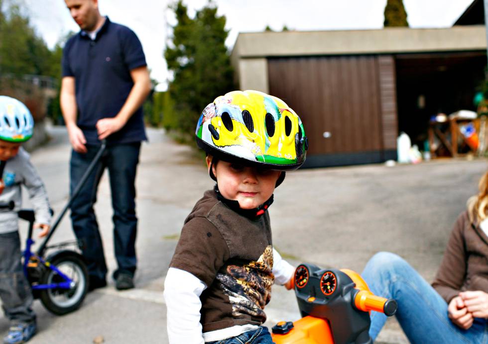 Bildet viser et par små barn med sykkelhjelm.