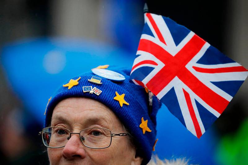 An anti-Brexit protester is seen in Parliament square in front of the Houses of Parliament in London on January 30, 2020. - Britain will leave the European Union formally at 2300GMT on January 31, 2020. (Photo by Tolga AKMEN / AFP)