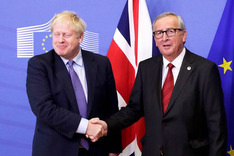 epa07927451 President of the European Comission Jean-Claude Juncker (R) and British Prime Minister Boris Johnson shake hands during a press conference on the Brexit deal in Brussels, Belgium, 17 October 2019. According to reports, the EU and the British government have reached a deal for Brexit.  EPA/OLIVIER HOSLET