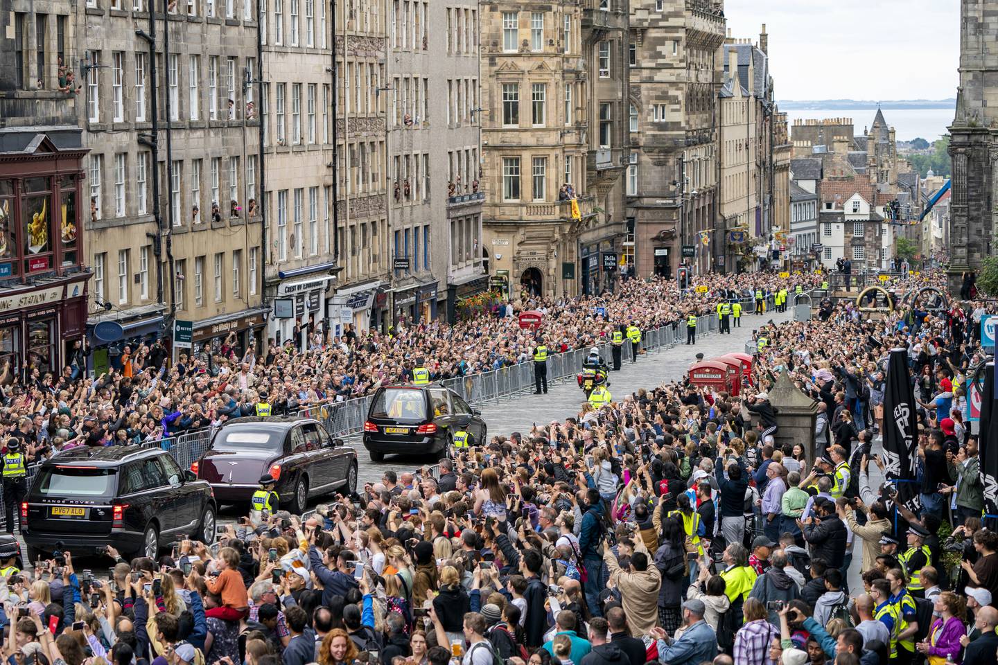Edinburghs gater var nærmest fylt til randen av folk da kortesjen med dronning Elizabeths kiste ankom den skotske hovedstaden søndag ettermiddag. Foto: Jane Barlow / AP / NTB
