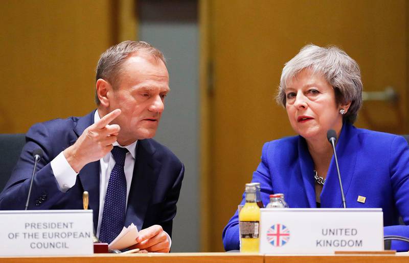 British Prime Minister Theresa May, right, and European Council President Donald Tusk attend a round table meeting at an EU summit in Brussels, Sunday, Nov. 25, 2018. European Union leaders are gathering to seal an agreement on Britain's departure from the bloc next year, the first time a member country will have left the 28-nation bloc. (Olivier Hoslet, Pool Photo via AP)