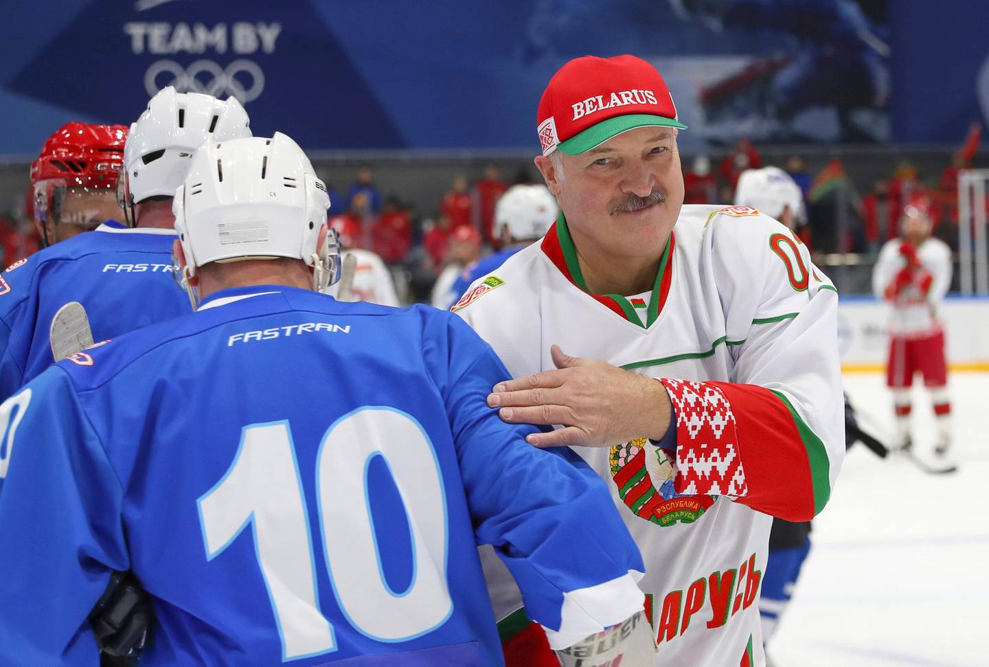 Belarusian President Alexander Lukashenko, right, takes part in a hockey match during Republican amateur competitions in Minsk, Belarus, Saturday, April 4, 2020. Amid concern about the coronavirus pandemic, Belarus' president made a public appearance in protective gear much different from the face masks and hazmat suits seen around the world. The new coronavirus causes mild or moderate symptoms for most people, but for some, especially older adults and people with existing health problems, it can cause more severe illness or death. (Andrei Pokumeiko/BelTA Pool Photo via AP)
