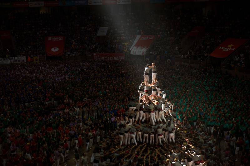 Members of "Castellers de Sants" complete their human tower during the 27th Human Tower Competition in Tarragona, Spain, on Sunday, Oct. 7, 2018. The tradition of building human towers or "castells" dates back to the 18th century and takes place during festivals in Catalonia, where "colles" or teams compete to build the tallest and most complicated towers. "Castells" were declared by UNESCO one of the Masterpieces of the Oral and Intangible Heritage of Humanity. (AP Photo/Emilio Morenatti)