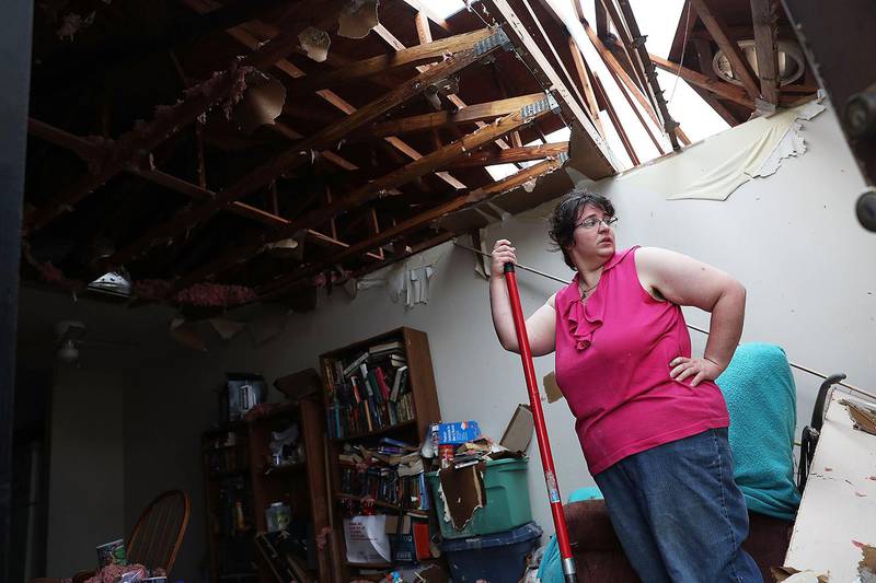 PANAMA CITY, FL - OCTOBER 11: Amanda Logsdon begins the process of trying to clean up her home after the roof was blown off by the passing winds of Hurricane Michael on October 11, 2018 in Panama City, Florida. The hurricane hit the Florida Panhandle as a category 4 storm.   Joe Raedle/Getty Images/AFP
== FOR NEWSPAPERS, INTERNET, TELCOS & TELEVISION USE ONLY ==