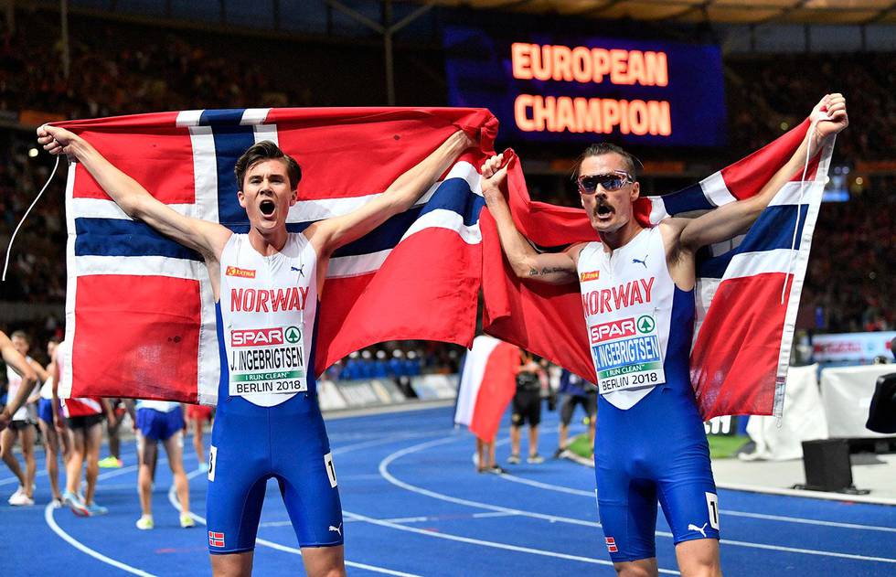 Norway's gold medal winner Jakob Ingebrigtsen, left, and silver medal winner Henrik Ingebrigtsen celebrate after the men's 5000-meter final at the European Athletics Championships at the Olympic stadium in Berlin, Germany, Saturday, Aug. 11, 2018. (AP Photo/Martin Meissner)