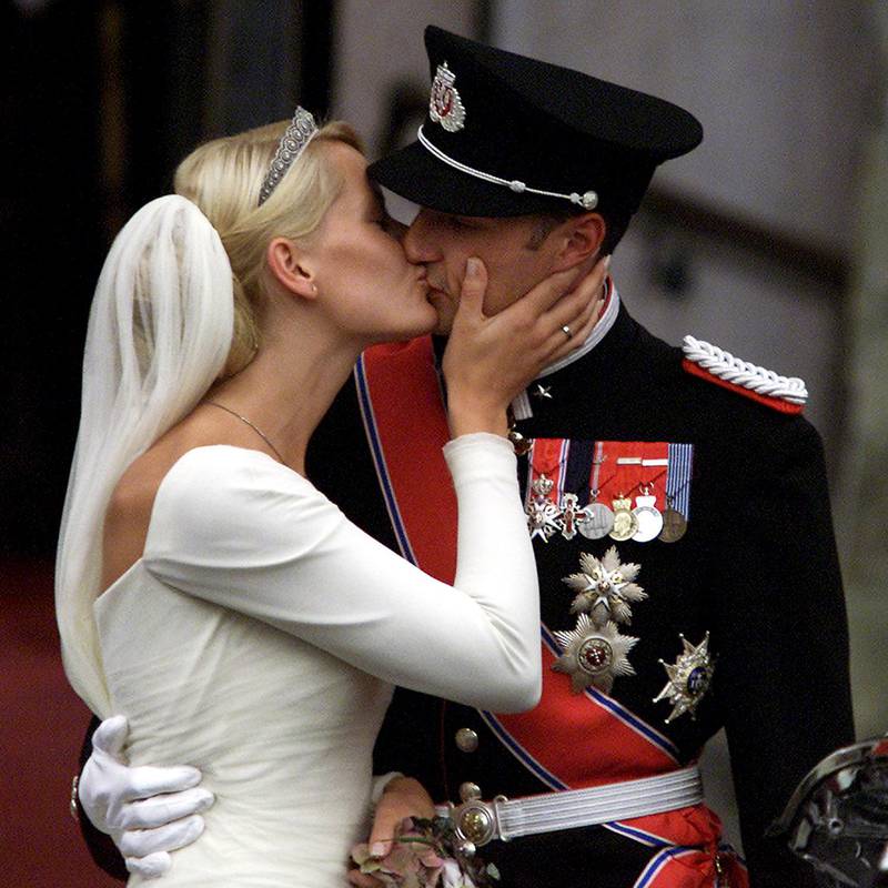 
OSLO 20010825: Kongelig bryllup. Kronprins Haakon og kronprinsesse Mette-Marit ble viet av biskop Gunnar Stålsett i Oslo Domkirke lørdag ettermiddag. Her kysser brudeparet på kirketrappen etter vielsen. På kronprinsessens hånd ser man gifteringen.
Foto: Lise Åserud / SCANPIX / POOL