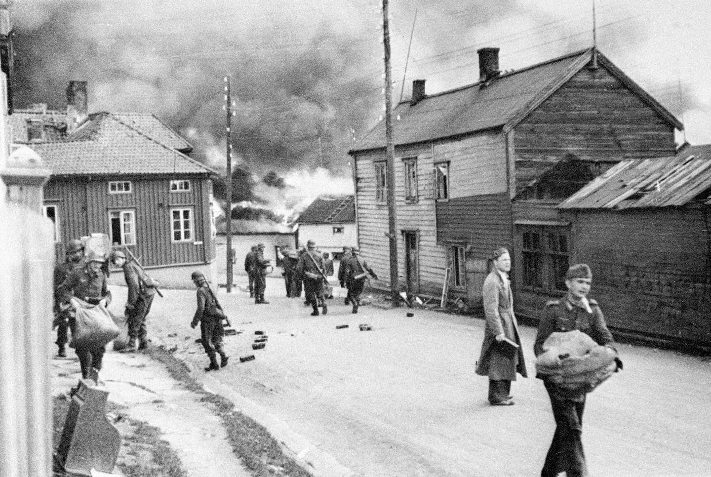 Bildet viser folk i Vadsø i 1944. Tyskerne satte fyr på byen. Foto: NTB