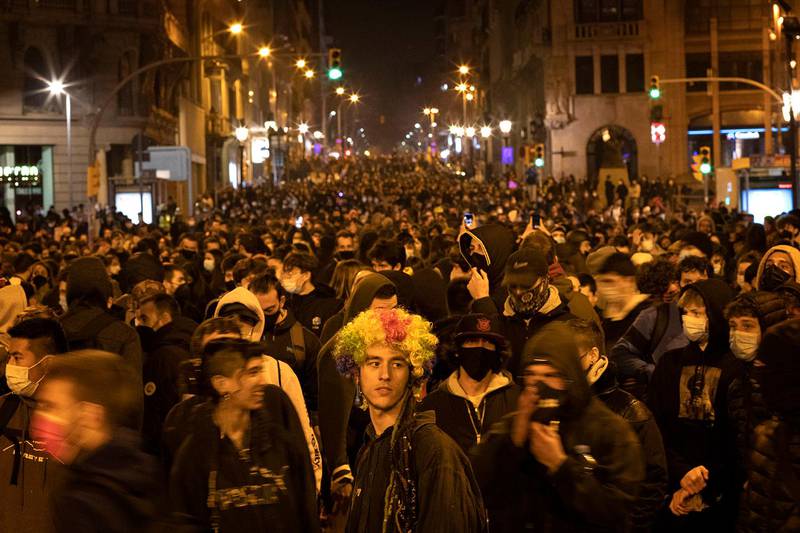 Demonstrators march during a protest condemning the arrest of rap singer Pablo Hasél in Barcelona, Spain, Friday, Feb. 19, 2021. Violent street protests over the imprisonment of a rapper have erupted for a fourth straight night in Spain. Police in the northeastern region of Catalonia said some protesters pelted officers with bottles, stones, fireworks and paint on Friday. (AP Photo/Emilio Morenatti)