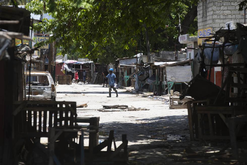 Nesten 150 er drept i brutale sammenstøt mellom kriminelle gjenger i Haitis hovedstad Port-au-Prince de siste ukene. Her krysser en mann en gate der de fleste bygningene er barrikadert som følge av uroen. Foto: Odelyn Joseph / AP / NTB
